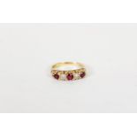 18cgt GOLD DIAMOND AND RUBY RING, with two small round brilliant cut diamonds between three small