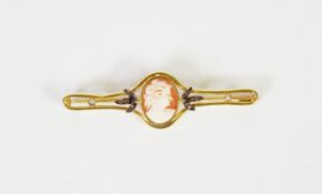 EARLY 20th CENTURY GOLD COLOURED METAL OPENWORK BROOCH, collet set with an oval shell cameo carved