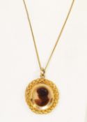 VICTORIAN CAMEO PENDANT, with dark amber glass head of a lady on plain glass oval, in gold
