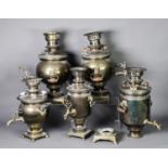 FIVE BRASS TWO HANDLED SAMOVARS, previously plated, 16” (40.6cm) high and smaller, (5), one a/f