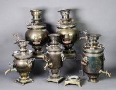 FIVE BRASS TWO HANDLED SAMOVARS, previously plated, 16” (40.6cm) high and smaller, (5), one a/f
