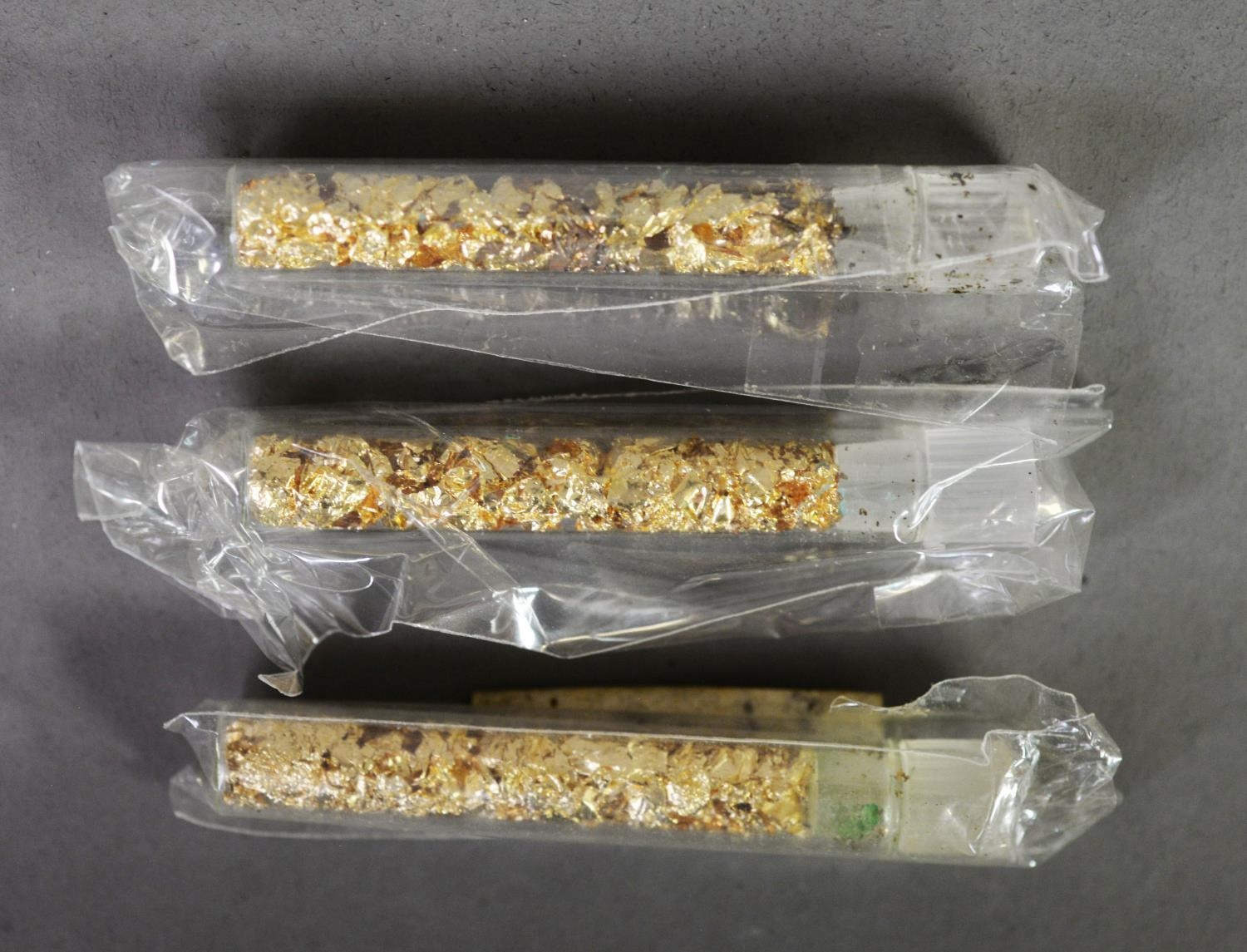 THREE FIFTY MM VIALS OF PURE GOLD FLAKES (24ct gold)