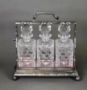 GOOD QUALITY, CIRCA 1920s ELECTROPLATE THREE BOTTLE TANTALUS, hinge top with barrel shape lock and