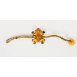UNUSUAL ETHNIC TWO-STRAND CORD BRACELET, the top in the form of a carved butterscotch amber frog,