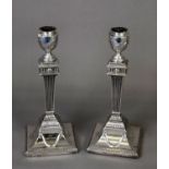 PAIR OF VICTORIAN WEIGHTED SILVER TABLE CANDLESTICKS IN THE NEO CLASSICAL STYLE, each with urn