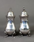 PAIR OF GEORGE V SILVER PEPPERETTES, each of square form with cyma border, pull-off cover and pad