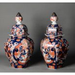 PAIR OF JAPANESE MEIJI PERIOD IMARI PORCELAIN JARS AND COVERS, each of panelled ovoid for with