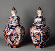PAIR OF JAPANESE MEIJI PERIOD IMARI PORCELAIN JARS AND COVERS, each of panelled ovoid for with