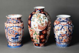 THREE JAPANESE MEIJI PERION IMARI PORCELAIN VASES, one of ovoid form, decorated with panels