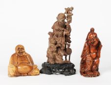 THREE EARLY TWENTIETH CENTURY AND LATER ORIENTAL CARVED WOOD FIGURES, comprising: TWO OF SAGES,