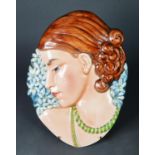 ART DECO MOULDED POTTERY FEMALE WALL MASK, of oval form, painted in colours and modelled in profile,