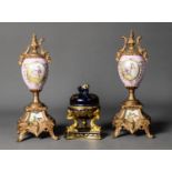 PAIR OF LATE NINETEENTH/ EARLY TWENTIETH CENTURY GILT METAL AND PORCELAIN PEDESTAL URNS,