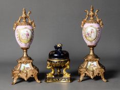 PAIR OF LATE NINETEENTH/ EARLY TWENTIETH CENTURY GILT METAL AND PORCELAIN PEDESTAL URNS,