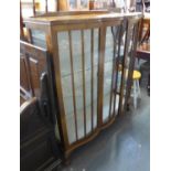 A PRE-WAR DOUBLE DOOR DISPLAY CABINET, HAVING TWO GLASS SHELVES, RAISED ON CLAW AND BALL FEET