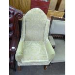 PRE-WAR WINGED FIRESIDE ARMCHAIR, WITH ARCHED BACK, UPHOLSTERED AND COVERED IN PALE GREEN CUT VELVET