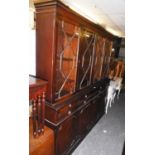 A MAHOGANY REPRODUCTION LIBRARY BOOKCASE, THE UPPER SECTION HAVING FOUR ASTRAGAL GLAZED DOORS, ABOVE