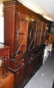 A MAHOGANY REPRODUCTION LIBRARY BOOKCASE, THE UPPER SECTION HAVING FOUR ASTRAGAL GLAZED DOORS, ABOVE