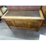 AN OAK BLANKET CHEST WITH LINEN FOLD PANELS