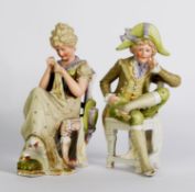 PAIR OF NINETEENTH CENTURY CONTINENTAL TINTED BISQUE FIGURES, heightened in green and gilt and