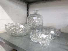 A LARGE BARREL SHAPED CUT GLASS PUNCH BOWL AND COVER, A SET OF NINE PUNCH CUPS, A LARGE STUART CUT