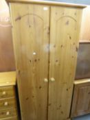 A MODERN WAXED PINE SMALL TWO DOOR WARDROBE, A MATCHING 4 DRAWER CHEST AND A DOUBLE HEADBOARD (3)