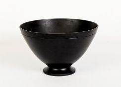KEITH MURRAY FOR WEDGWOOD, BLACK BASALT POTTERY BOWL, of flared, footed form with indented border