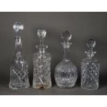 FOUR TWENTIETH CENTURY CUT GLASS DECANTERS AND STOPPERS of cylindrical, ball and shaft, campana