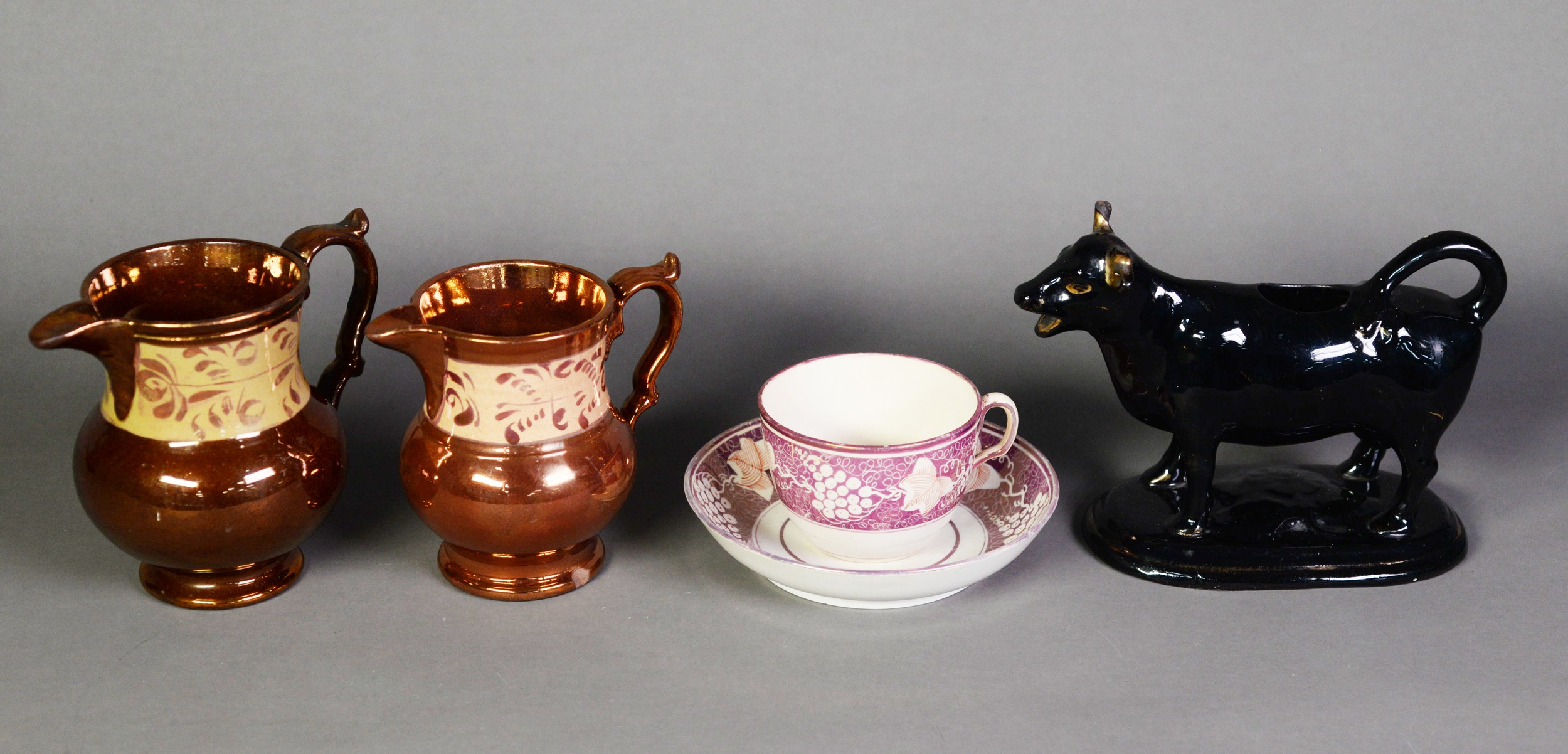 EARLY NINETEENTH CENTURY CREAM WARE TEA CUP AND SAUCER, both with broad fruiting vine decorated