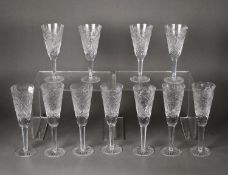 SET OF SEVEN CUT GLASS CHAMPAGNE FLUTES, on hexagonally panelled tapering stems and star cut bases