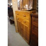 AN OAK UTILITY TALLBOY CABINET, HAVING TWO DRAWERS OVER TWO CUPBOARDS