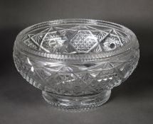 TWENTIETH CENTURY HEAVY CUT GLASS LARGE BOWL, of footed form, with star cut base, 6 ½” (16.5cm)