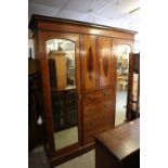 AN EDWARDIAN MAHOGANY INLAID TRIPLE WARDROBE, THE CENTRAL SECTION HAVING 2 PANEL DOORS OVER FOUR