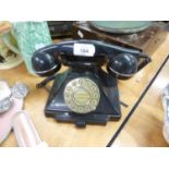 A VINTAGE BLACK BAKELITE ROTARY DIAL TELEPHONE RECEIVER