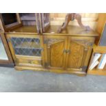 OLD CHARM STYLE OAK STEREO CABINET, HAVING LEADED GLAZED DOOR AND FAUX DOOR WITH TWO CUPBOARD DOORS
