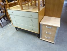 A LIGHT OAK CHEST OF FOUR LONG DRAWERS WITH WHITE FRONTS, ON EBONISED SUPPORTS WITH STRETCHER RAIL