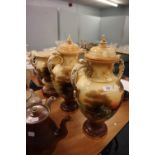 EARLY TWENTIETH CENTURY THREE PIECE POTTERY GARNITURE, comprising; PAIR OF TWO HANDLED VASES AND