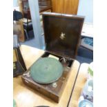 A SPRING DRIVEN TABLE TOP RECORD PLAYER IN WOODEN CASE