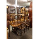 OAK REFECTORY DINING TABLE, ON TRESTLE END SUPPORTS AND A SET OF SIX OAK LADDER BACK DINING CHAIRS