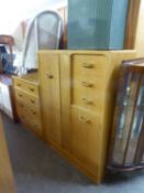 A G-PLAN LIGHT OAK BEDROOM SUITE OF TWO PIECES VIZ, A SMALL COMBINATION WARDROBE WITH DRAWERS AND