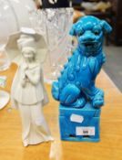 CHINESE BLUE GLAZED POTTERY DOG OF FO ORNAMENT AND AN ITALIAN PORCELAIN FEMALE FIGURE, WITH UMBRELLA
