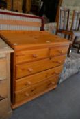 MODERN PINE CHEST OF TWO SHORT AND THREE GRADUATED LONG DRAWERS, WITH KNOB HANDLES, ON BUN FEET, 2’