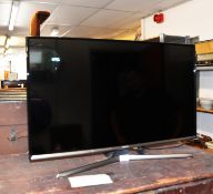SAMSUNG FLAT SCREEN TELEVISION, ON METAL SALTIRE BASE AND THE REMOTE CONTROL