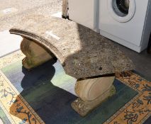 RECONSTITUTED STONE CURVED GARDEN SEAT, ON TWO SCROLL SUPPORTS, WITH PAW FEET
