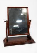 REGENCY FIGURED MAHOGANY TOILET MIRROR, the oblong plate housed in a chamfered frame and flanked
