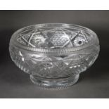 TWENTIETH CENTURY HEAVY CUT GLASS LARGE BOWL, of footed form, with star cut base, 6 ½” (16.5cm)