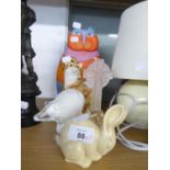 A SEATED RESIN MODEL OF A CAT, A TUSCAN DECORO POTTERY BUNNY, A WHITE OPAQUE GLASS POLAR BEAR