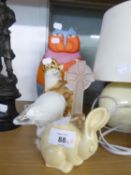 A SEATED RESIN MODEL OF A CAT, A TUSCAN DECORO POTTERY BUNNY, A WHITE OPAQUE GLASS POLAR BEAR
