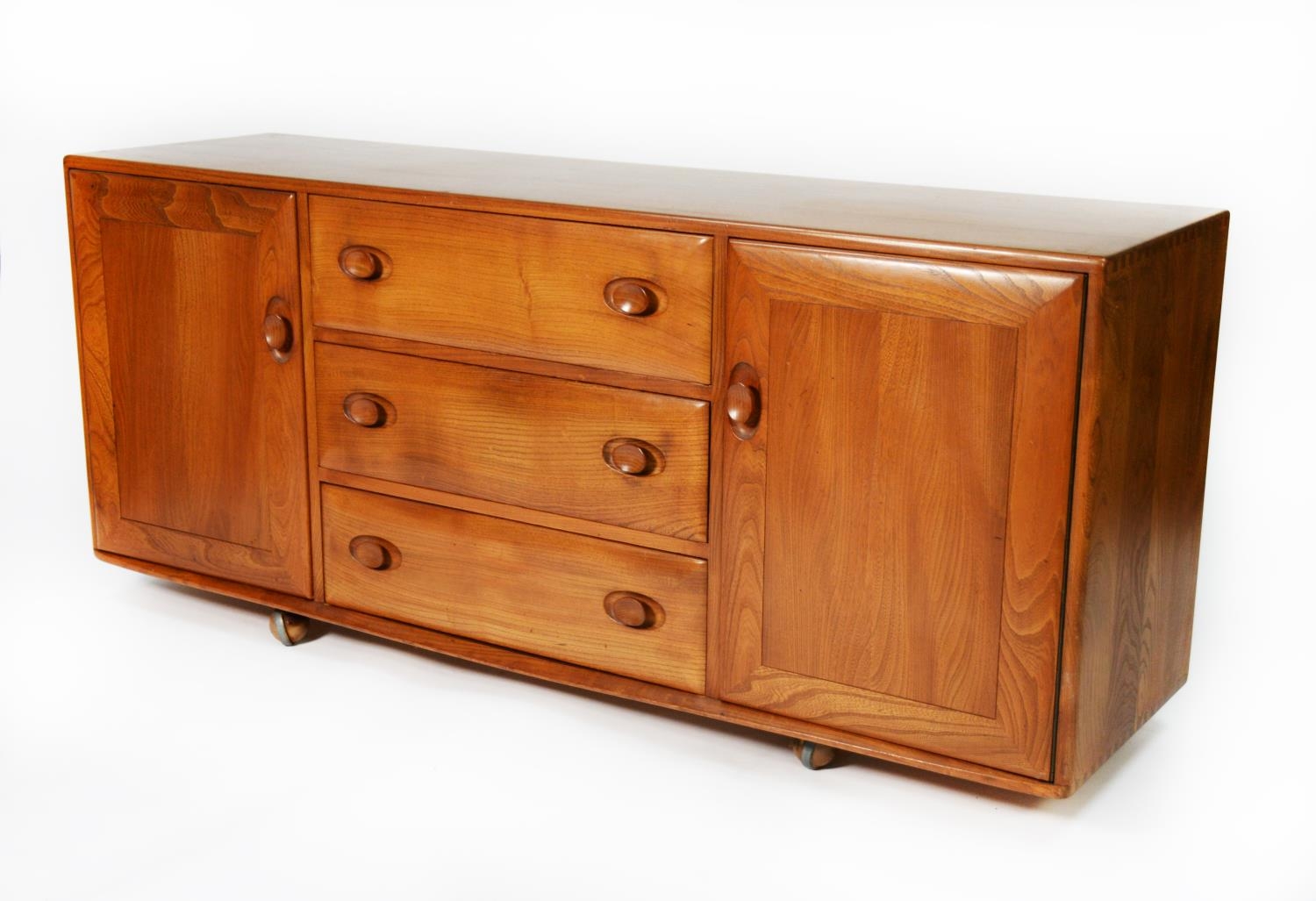 ERCOL LIGHT STAINED ELM SIDEBOARD, the oblong top above a central bank of three drawers, the top - Image 2 of 3