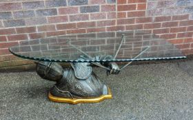 GLASS AND IRON COFFEE TABLE, WITH THE BASE IN THE FORM OF A KNIGHT HOLDING THE GLASS TOP AS A SHIELD