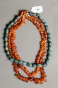 TWO GOLDEN TRANSLUSCENT CHIP AMBER BEAD NECKLACES AND A SINGLE STRAND NECKLACE OF GREEN JADITE